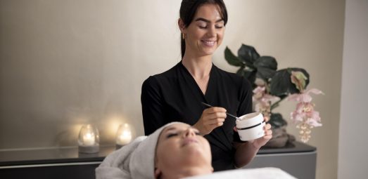 young-woman-using-face-treatment-her-client young-woman-using-face-treatment-her-client